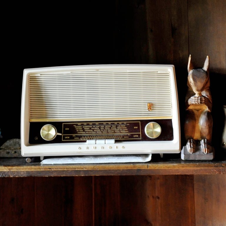 Das Kuba-Radio des Philospohen Martin Heidegger, ein altes Radio, steht auf einem Regalbrett neben Kleinkram wie Holzfiguren und einem Krüglein