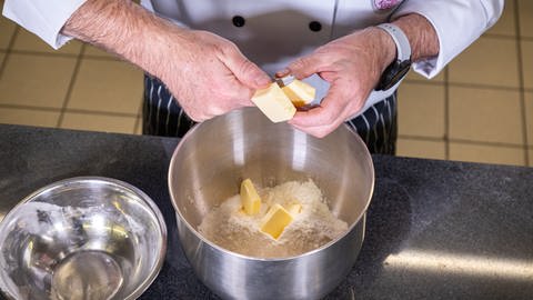 Herzhaftes Baguette mit Speckwürfel backen: Butter, Zucker, Salz und Hefe in eine Schüssel geben. 