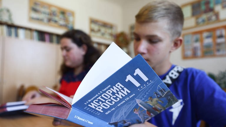 Schüler mit dem neuen russischen Geschichtsbuch