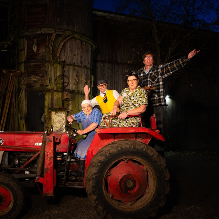 Comedy Duos Hillu's Herzdropfa (Hillu Stoll, li. und Franz Auber) und Elsbeth und Alois Gscheidle (Birgit Pfeiffer und Marcus Neuweiler, re.) sitzen auf einem roten Traktor (Foto: SWR)
