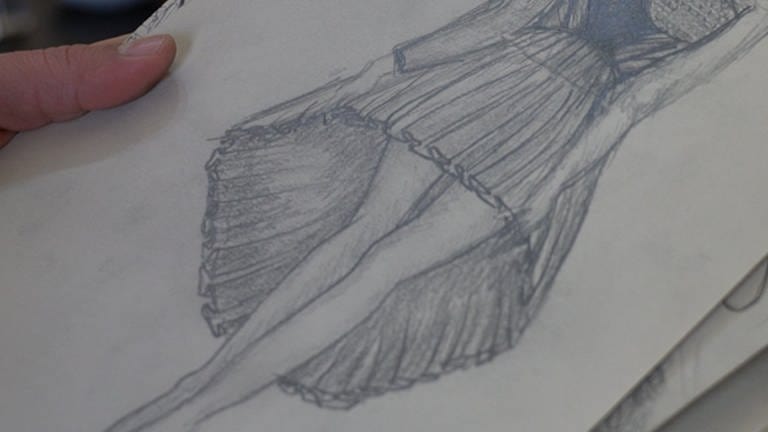 Ein Zeichenblock mit der gezeichneten Abbildung eines Sommerkleides. (Foto: SWR)