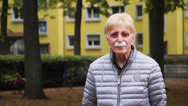 Hans-Jürgen, älterer Mann mit weißen Haaren, lächelt in die Kamera