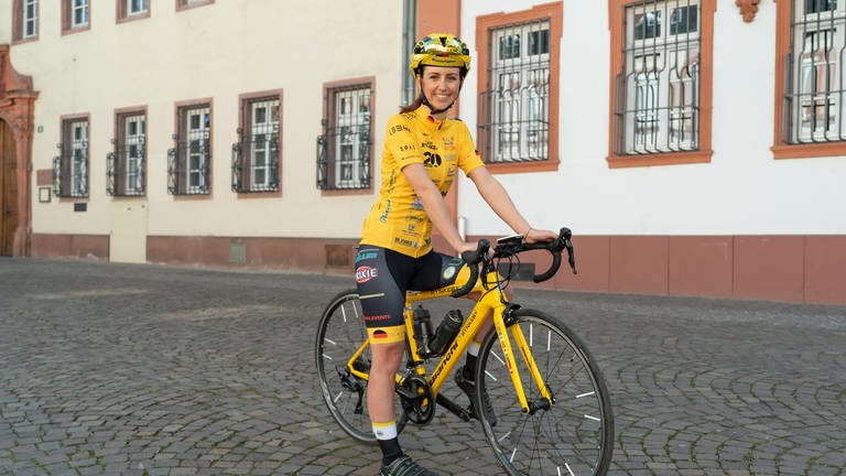 Lea auf ihrem Rennrad sitzend. Alles ist in gelb-schwarz gehalten. (Foto: SWR)