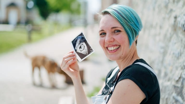 Tanja zeigt lachend ein Ultraschallbild ihres Kindes (Foto: SWR)