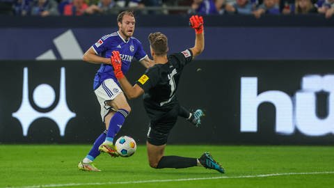FCK-Keeper Andreas Luthe grätscht Schalke-Verteidiger Thomas Ouwejan außerhalb des Strafraums um.