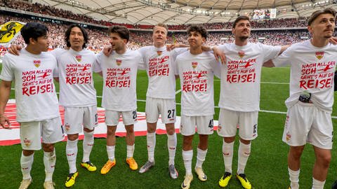 Leonidas Stergiou and andere VfB-Spieler stehen Arm in Arm vor der Cannstatter Kurve 
