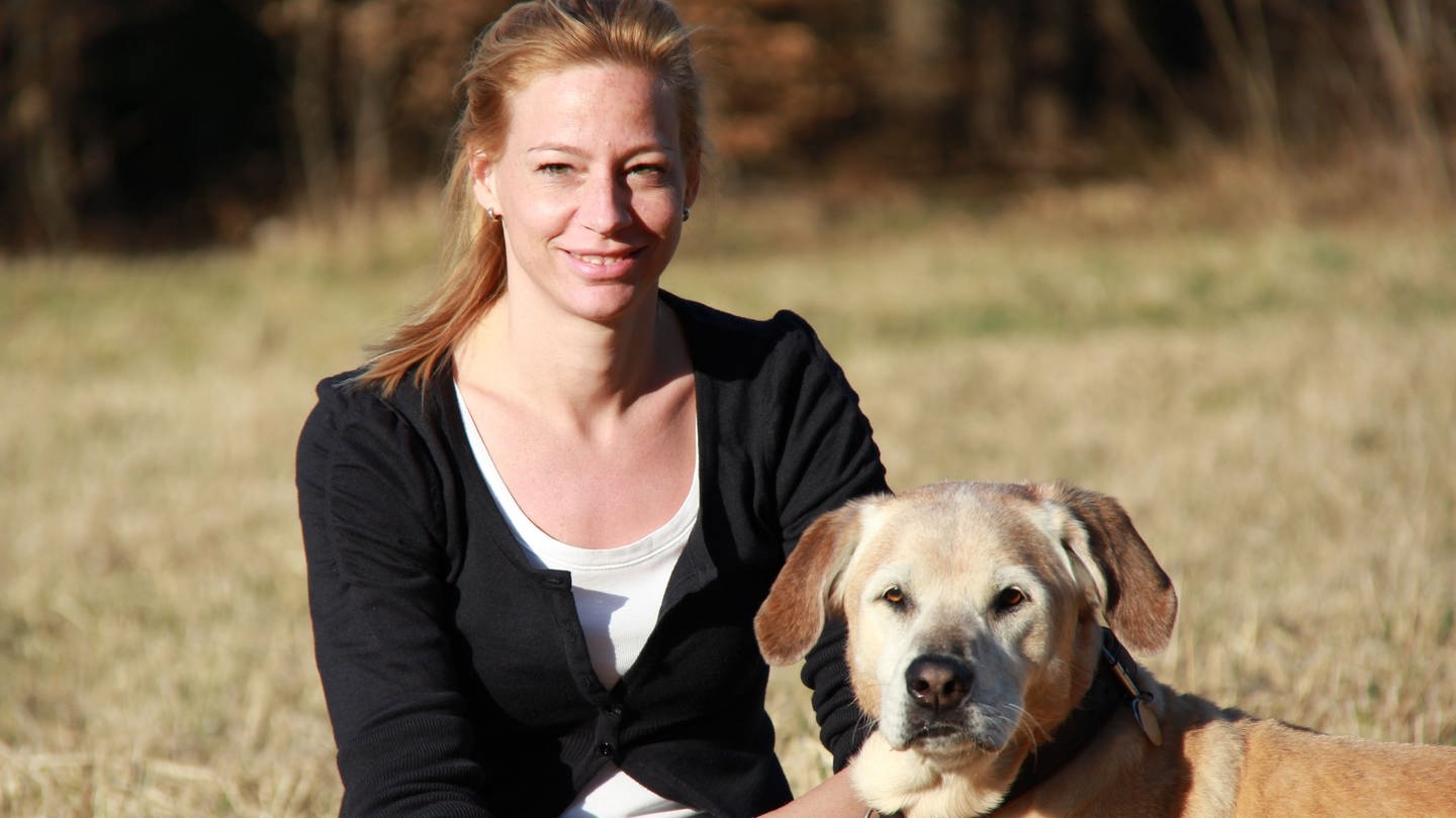 Julia Fritz sitzt mit ihrem Hund im Grünen. (Foto: Julia Fritz)
