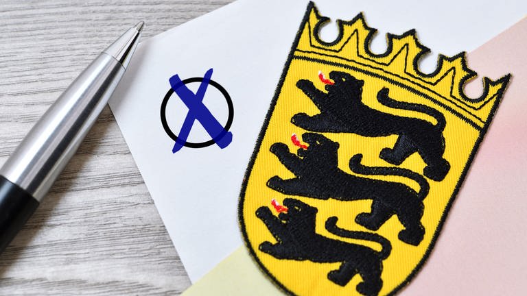 Hier findet ihr alles, was ihr rund um die Kommunalwahl in Baden-Württemberg wissen müsst. Das Bild zeigt das Wappen von Baden-Württemberg auf einem stilisierten Wahlzettel