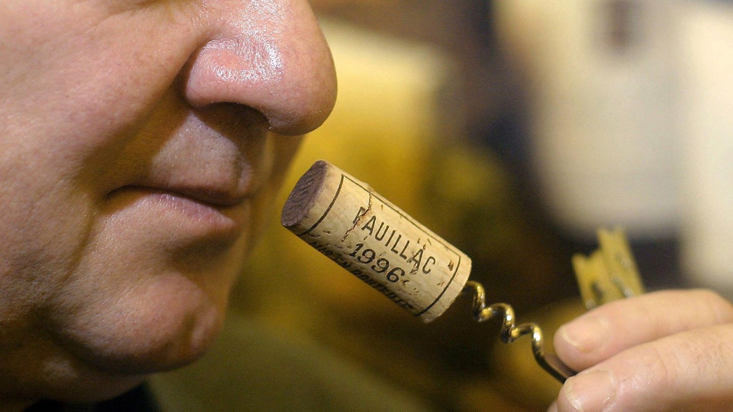 Mann riecht an einem Weinkorken (Foto: dpa Bildfunk, Picture Alliance)