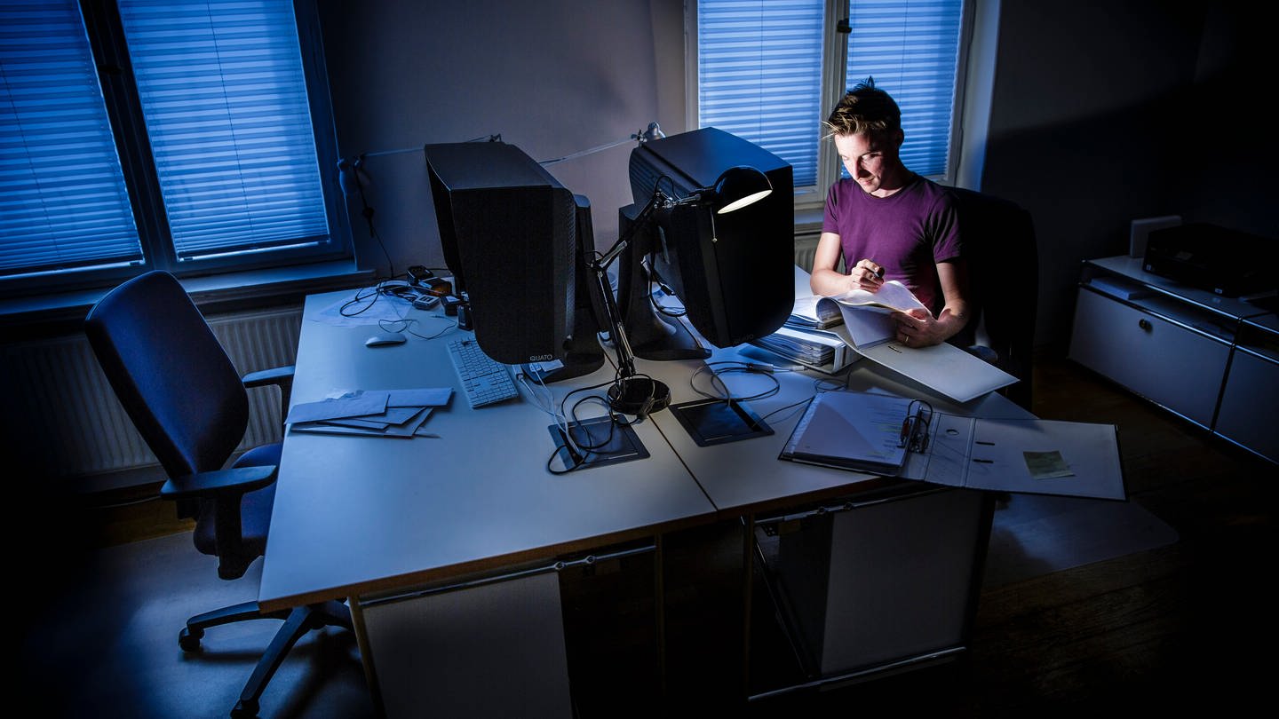 Ein Mann arbeitet nachts in einem Büro an einem Computer, er ist überlastet. (Foto: picture-alliance / Reportdienste, picture alliance / photothek | Thomas Trutschel)
