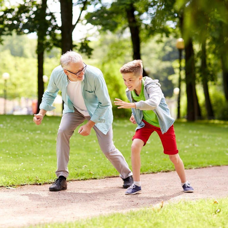 Älterer Mann und Junge rennen auf einer Wiese (Foto: Colourbox, Syda Productions)