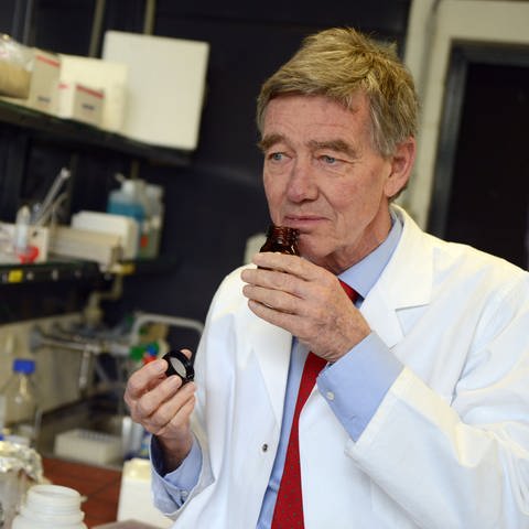 Geruchsforscher Hanns Hatt riecht im Labor an einem Fläschchen