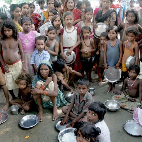 Kinder in Indien stehen in einem Lager bei Jankinagar in der nordindischen Region Bihar bei einer Essensausgabe von Helfern an (Foto: picture-alliance / Reportdienste, picture-alliance/ dpa | epa Piyal Adhikary)