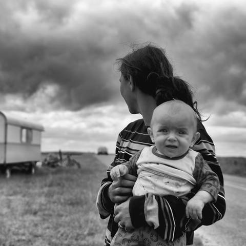 Eine junge Frau mit abgewandtem Blick hält ein Baby auf dem Arm (Foto: Pressestelle, Photo by Johann Walter Bantz on unsplash)