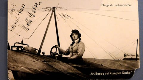 Eine Postkarte mit Autogramm von Melli Beese, die sie am Steuer eines Motorflugzeugs zeigt. (Foto: picture-alliance / Reportdienste, picture alliance / Bernd Oertwig/SCHROEWIG | Bernd Oertwig/SCHROEWIG)