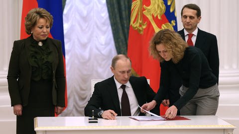 Russlands Präsident Wladimir Putin unterzeichnet am 21. März 2014 ein Dekret zur Eingliederung der Krim und Sewastopols in die Russische Föderation (Foto: picture-alliance / Reportdienste, picture alliance / dpa | Korotayev Artyom)