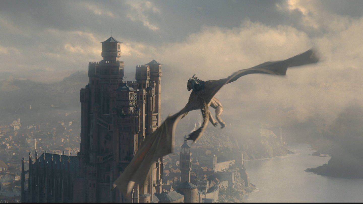 Ein Drache fliegt auf eine Burg zu in der Serie 