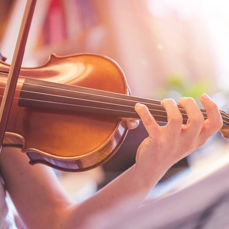 Finger einer jungen Geigerin liegen auf dem Hals der Violine: Es reicht nicht, 10.000 Stunden zu üben, um meisterlich in einem Fach zu werden. Aber: Talent allein reicht auch nicht.  (Foto: IMAGO, IMAGO / YAY Images)
