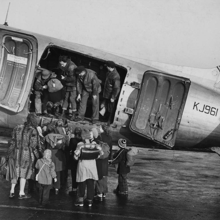 Kinder stehen am 5. November 1948 vor der britischen "Douglas Dakota" KJ 961 auf dem Rollfeld des Berliner Flughafens Tegel. Sie werden wegen des bevorstehenden Winters zu Verwandten in die westlichen Teile Deutschlands geflogen. (Foto: picture-alliance / Reportdienste, picture alliance / ASSOCIATED PRESS | Hans von Nolde)