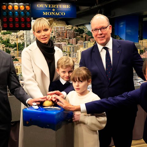 Fürst Albert II. von Monaco und seine Familie stehen mit den Gründern des Miniatur Wunderlandes, Gerrit Braun und Frederik Braun, vor der Kulisse von Mini-Monaco in Hamburg und eröffnen mit einem goldenen Button den neuen Modellabschnitt.