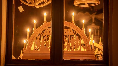 Weihnachtsdeko im Fenster: Ein Schwibboggen mit LED-Kerzen. (Foto: picture-alliance / Reportdienste, picture alliance/dpa/dpa-Zentralbild | Bernd März)