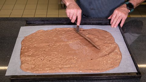 Der Bisquit-Teig für das Apfel-Lebkuchen-Dessert wird auf ein Backblech gestrichen. (Foto: SWR, Corinna Holzer)