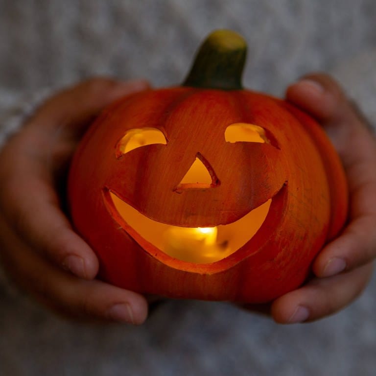 Halloween-Deko-Trends 2023: ein lächelnder Kürbis mit Gesicht und Kerze (Foto: IMAGO, IMAGO / Bihlmayerfotografie)
