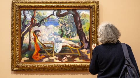 Eine Museumsbesucherin schaut sich ein Bild des französischen Malers Henri-Charles Manguin an.