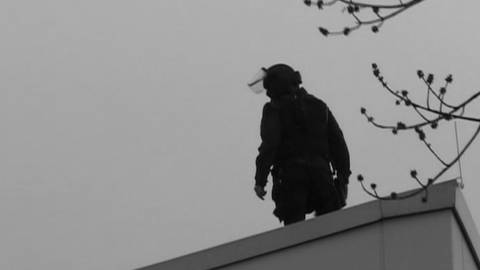 Ein Polizist steht beim Amoklauf von Winnenden auf einem Dach (Foto: SWR)