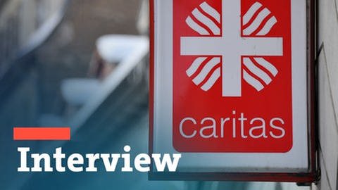 Caritas-Logo mit Interview-Ecke. (Foto: dpa Bildfunk, picture alliance/dpa/dpa-Zentralbild | Martin Schutt)