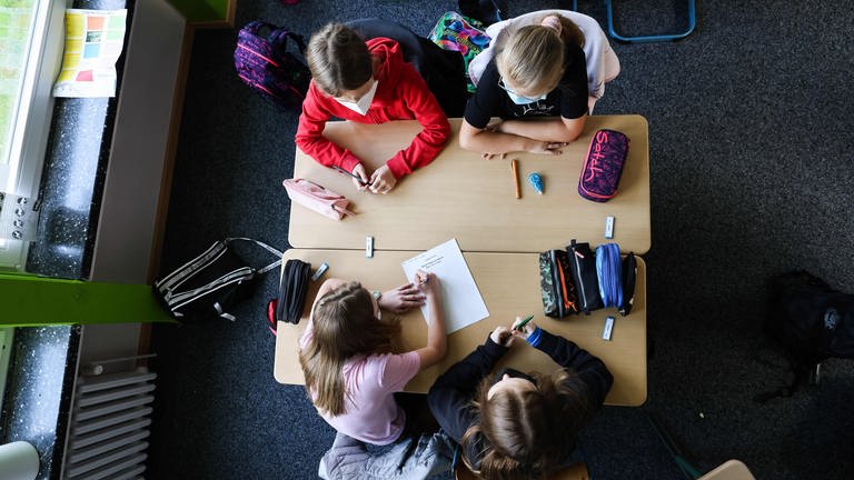 Schülerinnen und Schüler einer sechsten Klasse in einer Gruppenarbeit im Klassenzimmer.  (Foto: dpa Bildfunk, picture alliance/dpa | Christian Charisius)