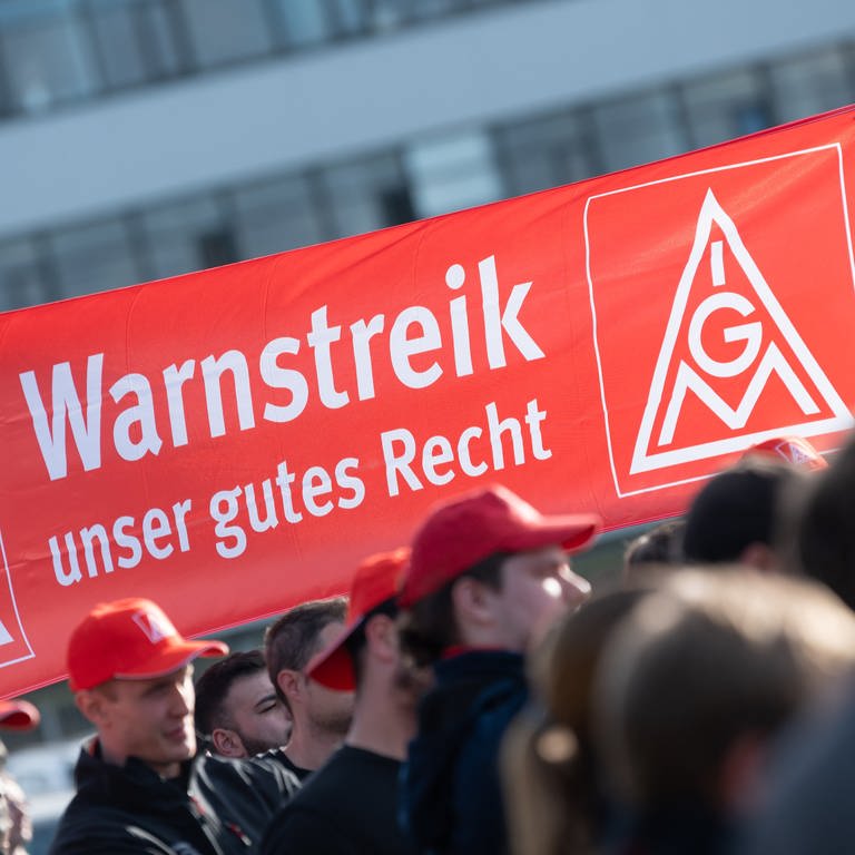 Teilnehmer einer Kundgebung der Gewerkschaft IG Metall halten während eines Warnstreiks ein Transparent mit der Aufschrift "Warnstreik unser gutes Recht" in die Höhe. (Foto: dpa Bildfunk, picture alliance/dpa | Silas Stein)