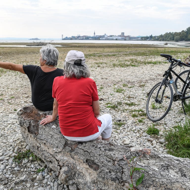 Zwei Seniorinnen sitzen nach einer Radtour vor Friedrichshafen am Ufer des Bodensees. (Foto: dpa Bildfunk, picture alliance/dpa | Felix Kästle)