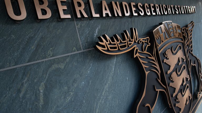 An dem Gebäude des Oberlandesgerichts (OLG Stuttgart) hängt unter dem Schriftzug das Wappen Baden-Württembergs. (Foto: dpa Bildfunk, picture alliance/dpa | Sebastian Gollnow)