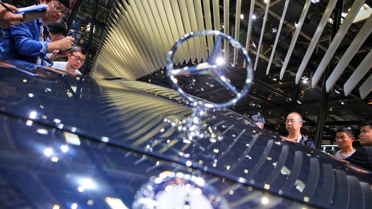 Visitors view a new Mercedes Benz E 320 L 4matic Sedan car at the Auto China 2016 motor show in Beijing, China, 26 April 2016. The 14th Beijing International Automotive exhibition or Auto China 2016 runs from 25 April to 04 May 2016. 