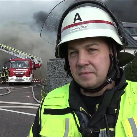 Feuerwehrmann vor einem brennenden Gebäude (Foto: SWR)