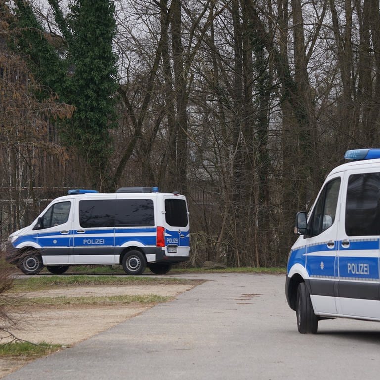 Zwei Streifenwagen verlassen einen Parkplatz in Radolfzell am Bodensee. Polizisten hatten in dem Gebiet in Ufernähe über Stunden nach einer vermissten 21-Jährigen gesucht. (zu dpa «Bekannter nach Verschwinden einer 21-Jährigen in U-Haft»)