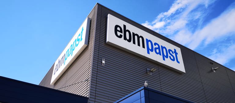 ebm papst Firmenlogo auf Werksgelände an einem Betriebsgebäude. (Foto: SWR)