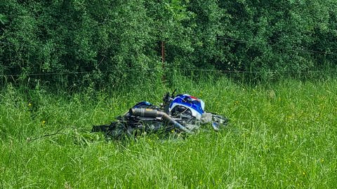 Ein Motorrad liegt nach einem Unfall auf einer Pferdekoppel