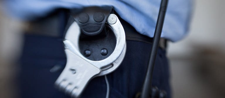 Handschellen eines Polizeibeamten (Symbolbild) (Foto: picture-alliance / Reportdienste, dpa Bildfunk, picture alliance/dpa | Friso Gentsch)