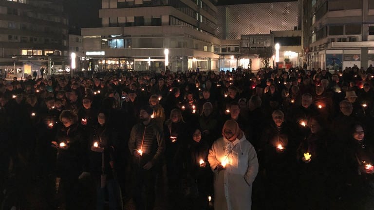 Menschen in Pforzheim gedenken am Abend mit einer Kerze in der Hand den Opfern der Bomennacht am 23. Februar 1945 (Foto: SWR, Daniel Günther)