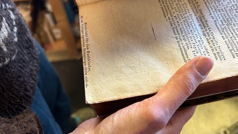 "Nachricht für den Buchbinder." Larissa Ebel aus Calw entdeckt in alten Büchern öfter mal kleine Überraschungen. (Foto: SWR, Mirka Tiede)