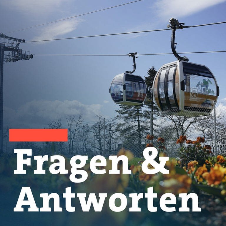 Kabinen der Seilbahn fahren auf dem Gelände der Bundesgartenschau hinter einem Blumenbeet. (Foto: dpa Bildfunk, picture alliance/dpa | Uwe Anspach)