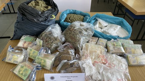 Päckchen mit Bargeld und Säcke voll mit verschiedenen Drogen (Foto: Polizeipräsidium Südhessen)