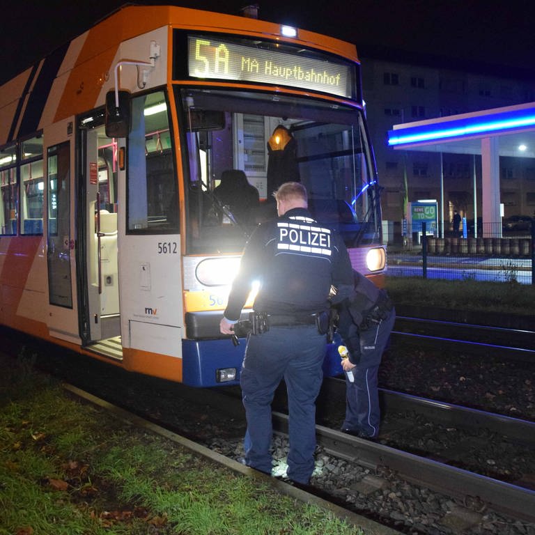 Bei einem Straßenbahnunfall in Mannheim kam ein Mann ums Leben. Zwei Polizisten untersuchen die Straßenbahn. (Foto: PR-Video, Marco Priebe)