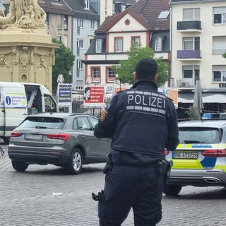 Einsatzkräfte der Polizei stehen auf dem Mannheimer Marktplatz