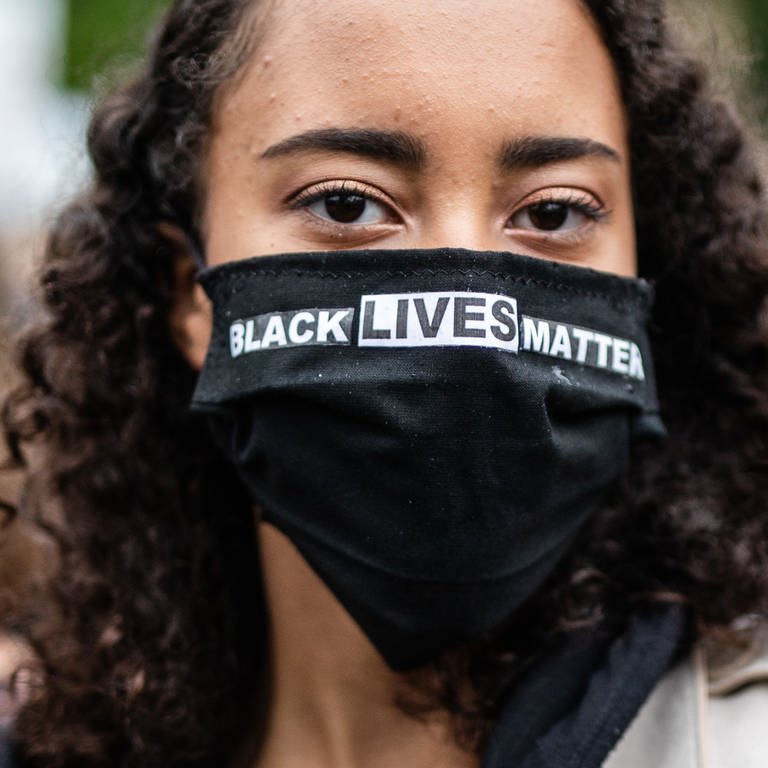 "Black Lives Matter" steht auf dem Mundschutz einer Teilnehmerin der Stuttgarter «Silent Demo» gegen Rassismus und Polizeigewalt im Oberen Schlossgarten geschrieben.