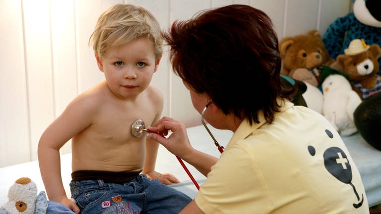Eine Kinderärztin untersucht in ihrer Praxis einen kleinen Jungen mit einem Stethoskop.  (Foto: dpa Bildfunk, picture alliance / dpa | Patrick Pleul)