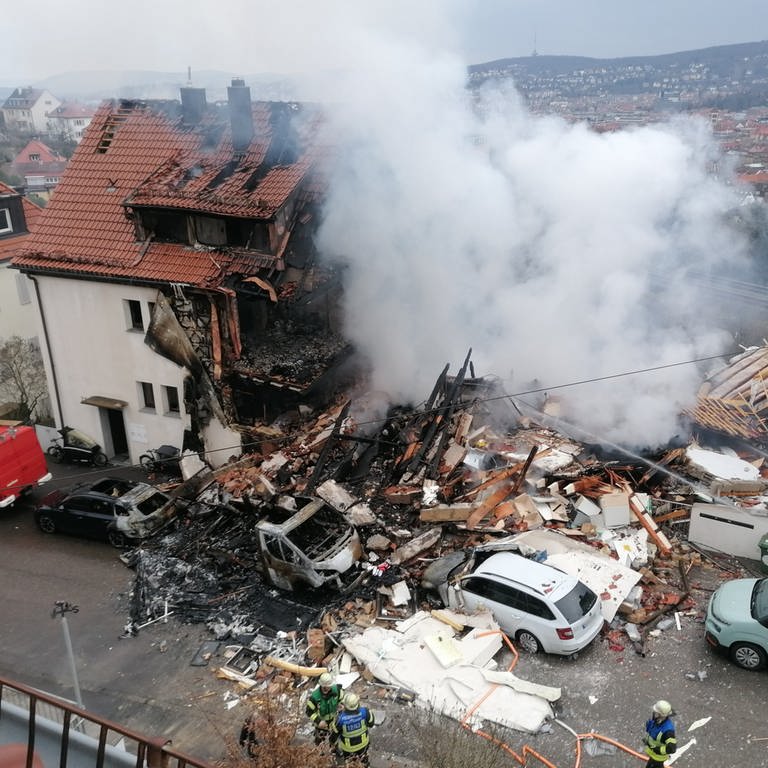 Nach der Explosion eines Doppelhauses in Stuttgart-West steht nur noch eine Haushälfte. Wo einst das Haus stand, liegen Trümmerberge, die qualmen. (Foto: dpa Bildfunk, picture alliance/dpa | Andreas Rosar)