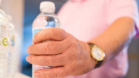 Seniorin greift nach Wasserflasche  (Foto: IMAGO, ABACAPRESS)
